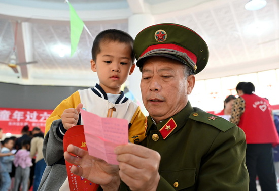老戰士與小朋友牽手參與有獎知識競答活動.jpg